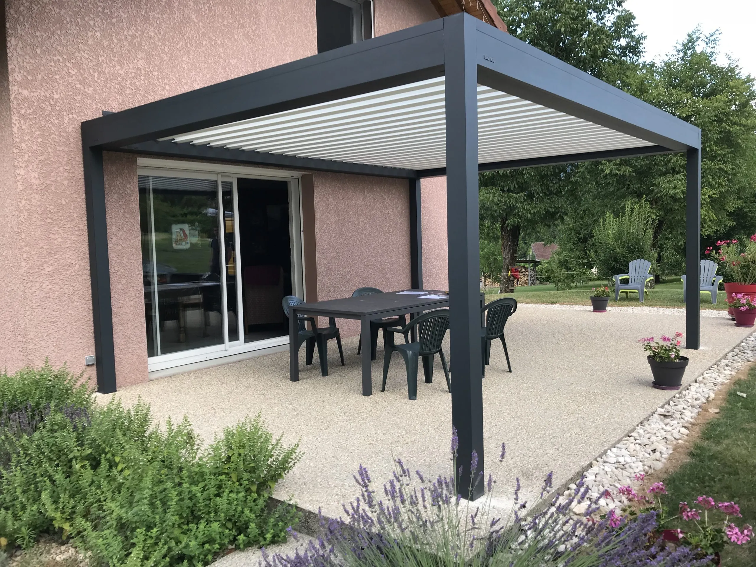 Pergola bioclimatique adossée à une maison contemporaine